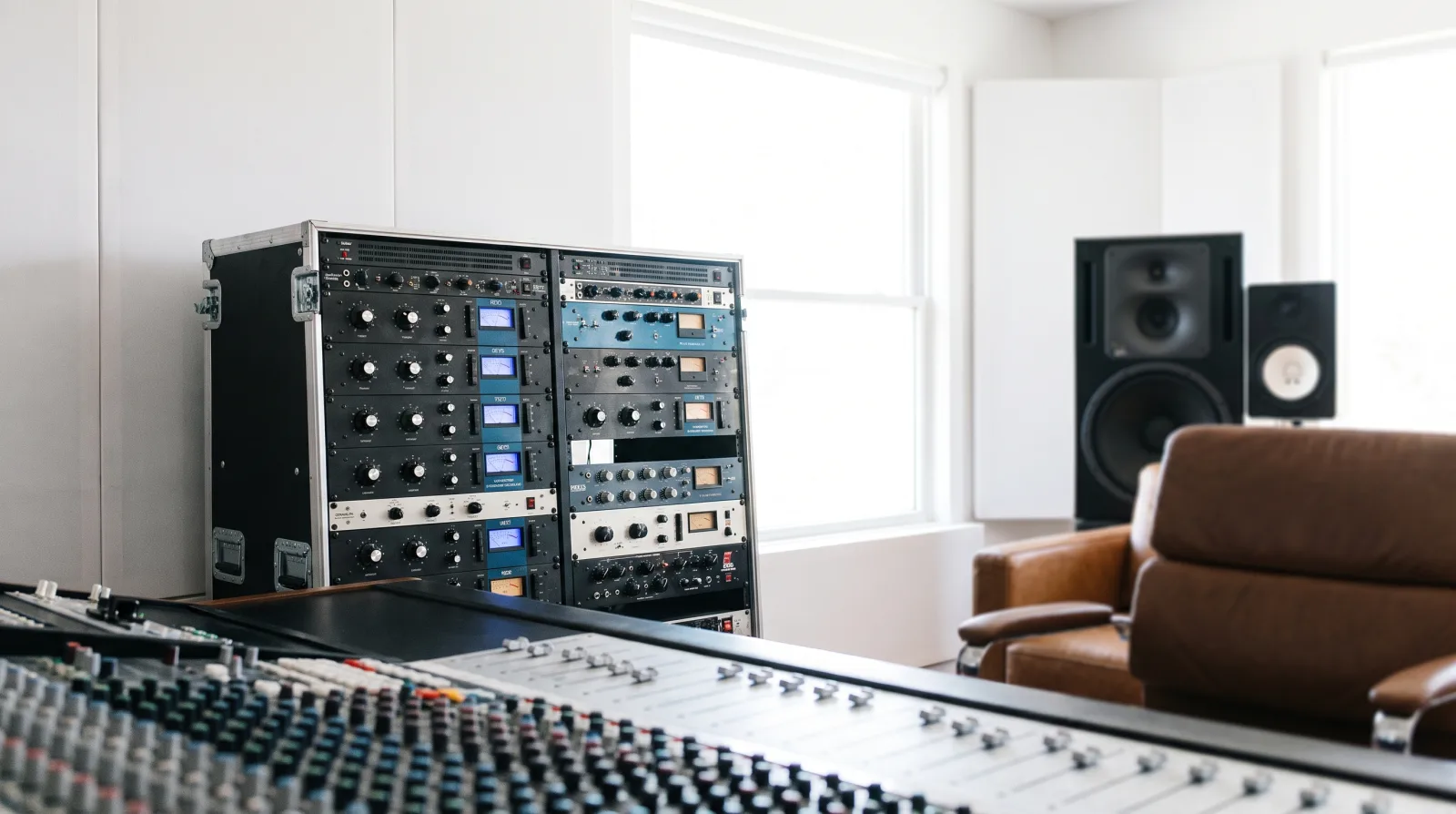 Mastering session with level meters and monitor speakers in daylight